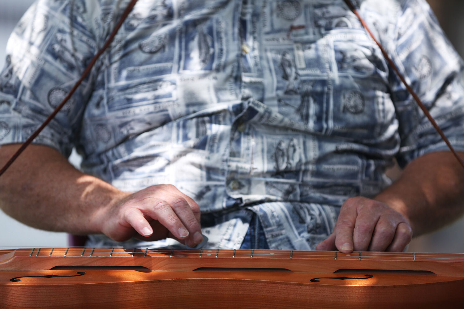 Steven Stransky strums the strings of his mountain dulcimer